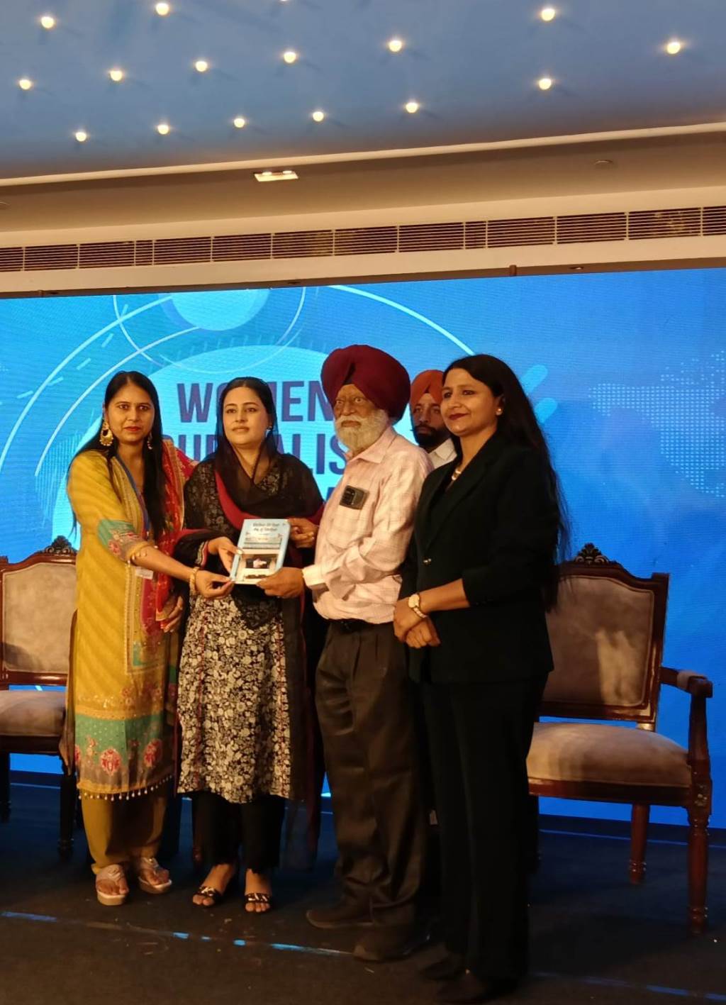 Principal Bahadur Singh Gosal presents his 122nd book to Dr Gurpreet Kaur Mann